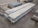 several pieces of metal are stacked on top of pallets in a warehouse