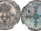 a silver coin with a crown on top of it