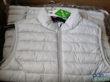 a white vest that is in a box with a tag on it