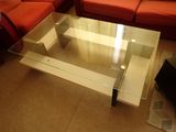 a glass coffee table with a glass top in a living room