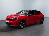 a red car parked in a room with a white wall