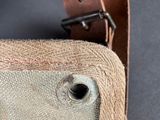 a close up of a canvas bag with a leather strap