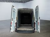 a white van with its doors open in a large room