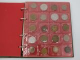 a red book with a bunch of coins inside of it