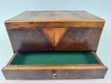 a wooden box with a green lid and a drawer inside