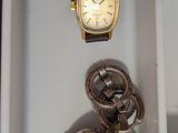 two watches and a watch sitting in a box