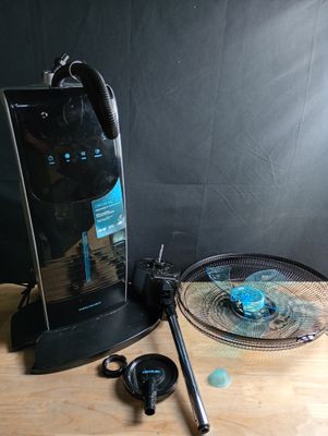 une table sur laquelle sont posés une raquette de tennis et un ventilateur