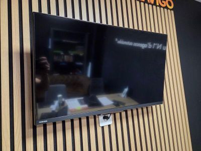 un téléviseur à écran plat fixé au mur d'une pièce