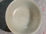 a white bowl sitting on a table with a measuring line
