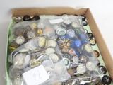 a box of assorted buttons in it on a white surface