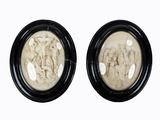 pair of black and white picture frames with figures on them
