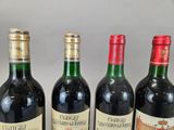 four bottles of wine are lined up on a table
