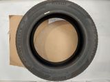 tires are stacked on top of a cardboard box on a shelf