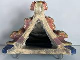 a figurine that is sitting on a stand