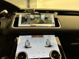 a tablet on the dashboard of a car with a view of a car
