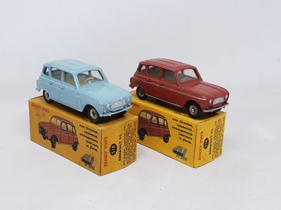 three toy cars sitting on top of boxes on a white surface