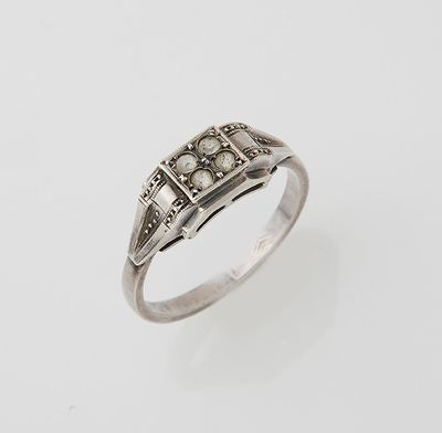 an antique silver ring with a diamond set in the center
