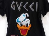 black t - shirt with a cartoon duck wearing a chef ' s hat on it