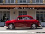 a red car parked in front of the hotel de londres