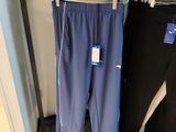 two pairs of pants hanging on a rack in a store
