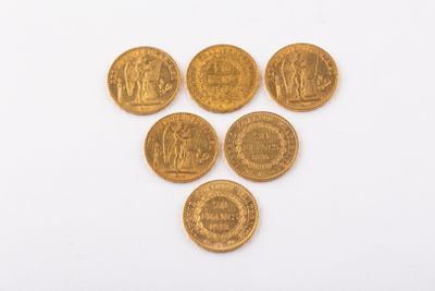 six gold coins are arranged in a triangle on a white surface