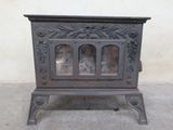 antique cast iron stove with glass doors and ornate design