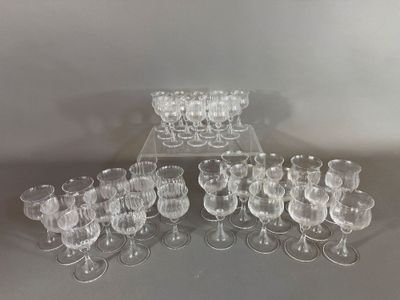several clear wine glasses are arranged on a glass stand
