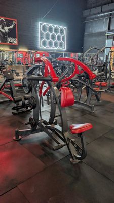 a gym with a lot of machines in the room