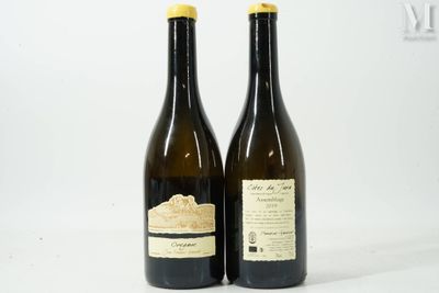 two bottles of wine sitting next to each other on a table