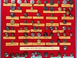 an image of a display of old coins on a red board