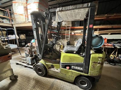 a forklift truck that is parked in a warehouse