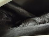 a close up of a black bag with a white handle