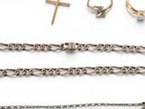 several pieces of jewelry including a cross, a ring, a chain, and a ring