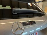 a close up of a mercedes car with a sticker on it