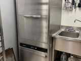 a stainless steel refrigerator and a sink in a kitchen