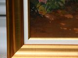a picture of a painting of flowers in a gold frame