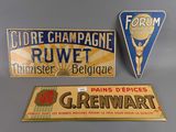 three different signs are displayed on a table in front of a gray background