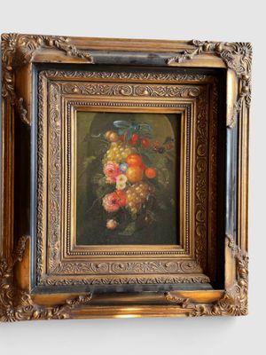 une photo d'un tableau représentant des fruits, dans un cadre doré