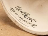 a close up of a white vase with writing on it