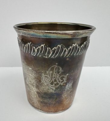 a silver vase with a design on it