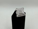 a white gold and diamond ring on a black stand