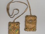 pair of small gold embroidered purses on a white surface