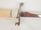 a close up of a knife with a rope attached to it