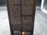 the back of a black box with a red, white, and blue label on it