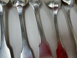 five spoons that are sitting next to each other on a table