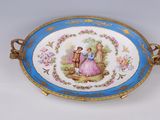 a blue and white plate with a picture of a man and a woman on it