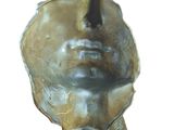 sculpture of a woman ' s face on a black marble base
