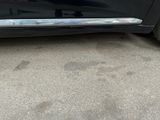 a black car parked on the side of the street