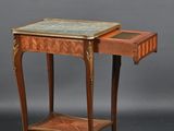 a small wooden table with a marble top and a shelf