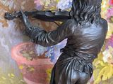 a statue of a woman that is playing a violin